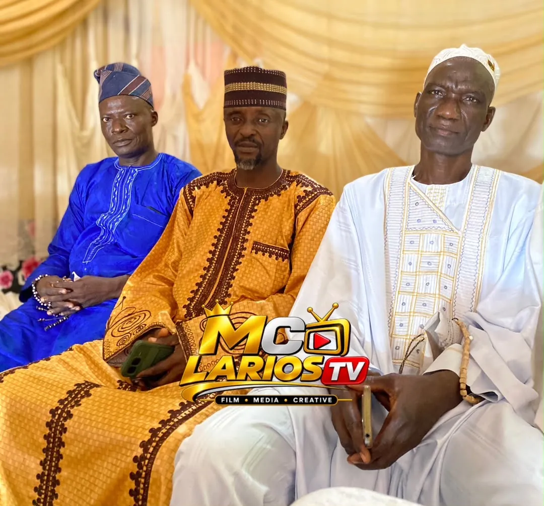 Guests in colourful robes seated in a row