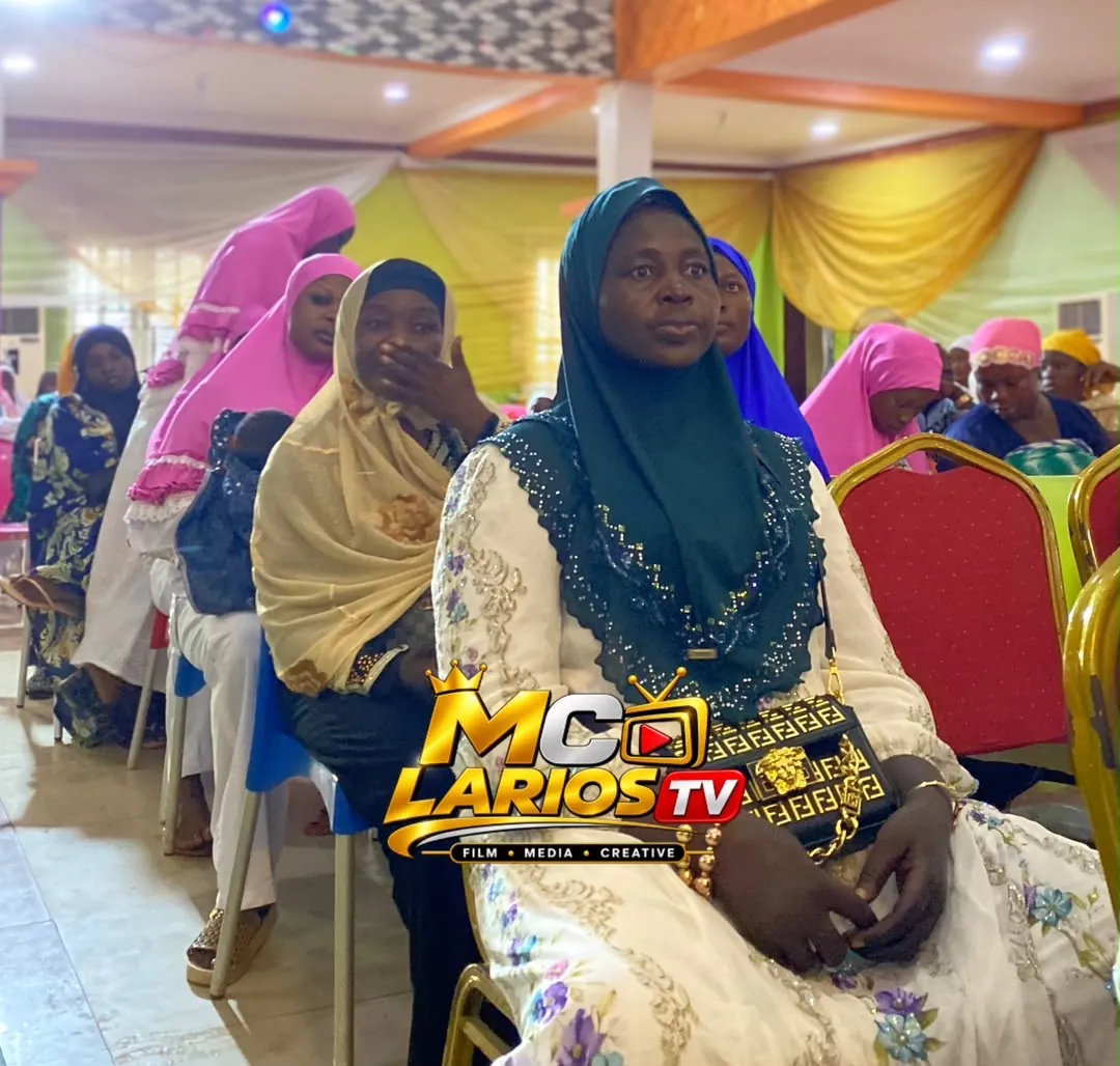 Women in hijabs seated in the audience